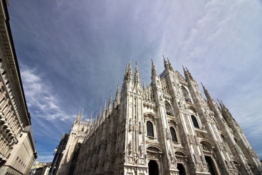 Milan, Lombardy, Italy, 04/27/2019. The facade of the cathedral with  blue sky. 