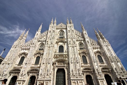 Milan, Lombardy, Italy, 04/27/2019. The facade of the cathedral with  blue sky. 