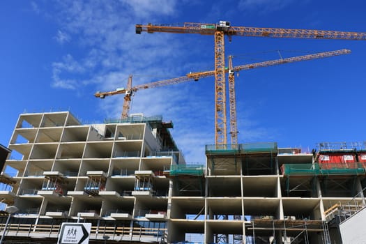 Amsterdam, Netherlands. About the July 2019. Construction site with cranes in Amsterdam. Construction of a new reinforced concrete building.