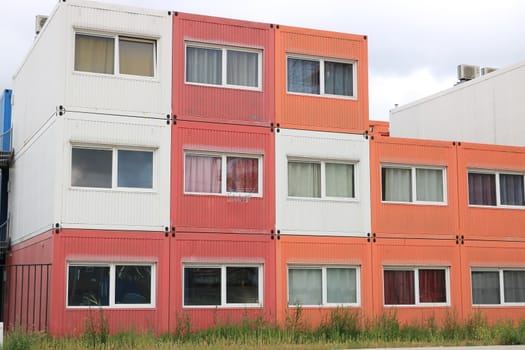 Amsterdam, NDSM, Netherlands. About the July 2019. Temporary housing in steel containers. Overlapping containers with small construction site apartments.