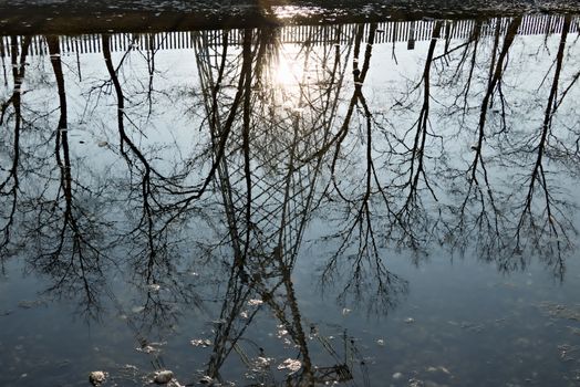 A jumper pole of a power line reflects on the riverbed. We are close to Milan (Turbigo), where a power line leaves from the power plant.