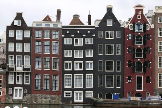 Amsterdam, Netherlands. About the July 2019. Terraced houses typical of the city of Amsterdam. Sloping facades due to subsidence of the foundations.