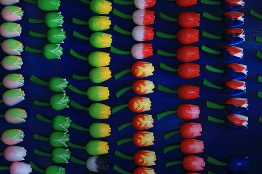 Wooden souvenirs of colorful tulip flowers in an Amsterdam market in the Netherlands.