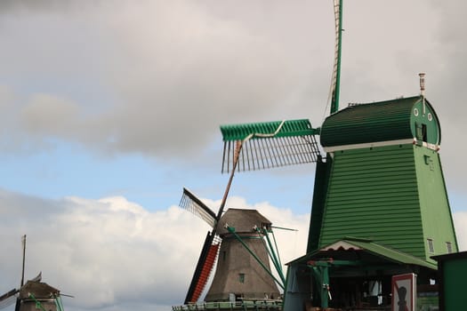 Amsterdam, Netherlands. About the July 2019.  Windmills of Zaanse Schans, near Amsterdam. The structures were used in the past to grind the cocoa beans used in nearby factories and to cut timber.