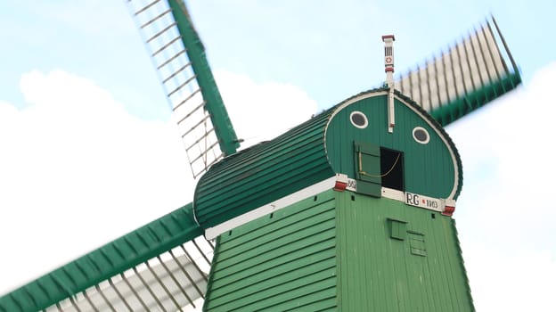 Amsterdam, Netherlands. About the July 2019.  Windmills of Zaanse Schans, near Amsterdam. The structures were used in the past to grind the cocoa beans used in nearby factories and to cut timber.