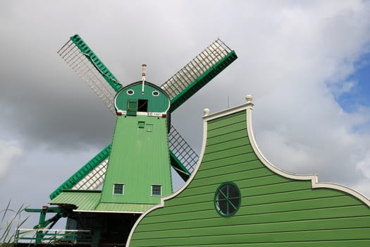 Amsterdam, Netherlands. About the July 2019.  Windmills of Zaanse Schans, near Amsterdam. The structures were used in the past to grind the cocoa beans used in nearby factories and to cut timber.