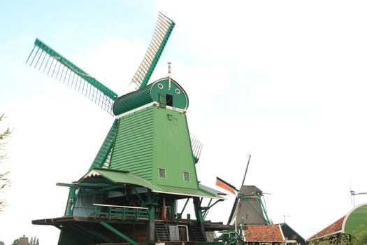 Amsterdam, Netherlands. About the July 2019.  Windmills of Zaanse Schans, near Amsterdam. The structures were used in the past to grind the cocoa beans used in nearby factories and to cut timber.