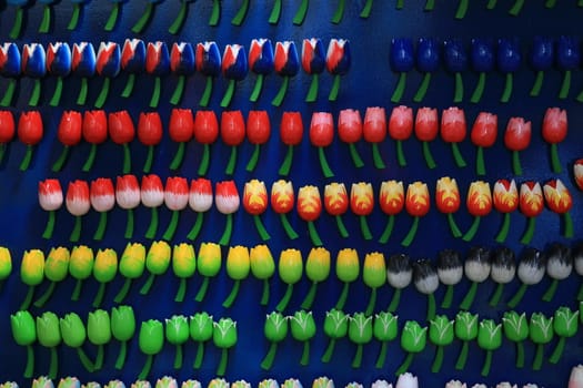 Wooden souvenirs of colorful tulip flowers in an Amsterdam market in the Netherlands.