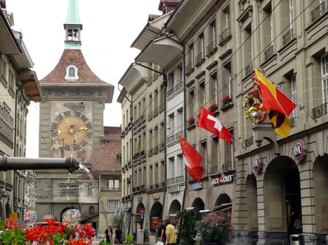 One of the main streets of the Swiss city with the background of the clock tower.