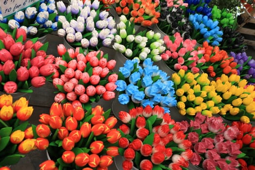 Wooden souvenirs of colorful tulip flowers in an Amsterdam market in the Netherlands.