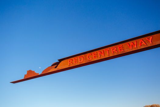 A marker and information spot for Lasseter Hwy directing towards Uluru and Kings Canyon in the Northern Territory, Australia