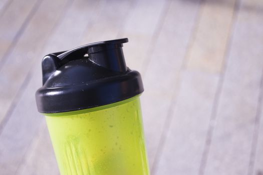 Transparent yellow shaker for sports drinks