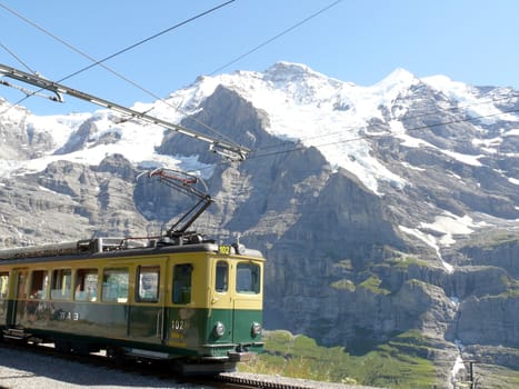 In the background the mountain range of the Jungfrau and Monch.