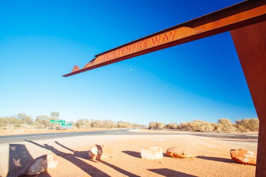 A marker and information spot for Lasseter Hwy directing towards Uluru and Kings Canyon in the Northern Territory, Australia