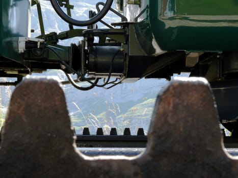 In the foreground, a detail of the rack that allows the train to climb up the mountains.