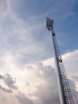 Sport light tower with sky in stadium