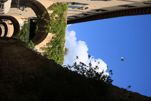 Walls with arches connected to the houses of Castiglione della Pescaia. An ancient village in the Tuscan Maremma built on a hill facing the sea.