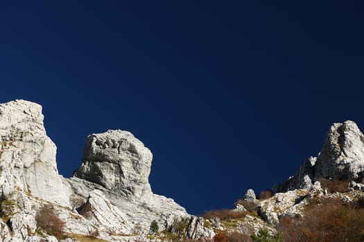 Details of mountains with a particular shape with a dark blue sky background.
