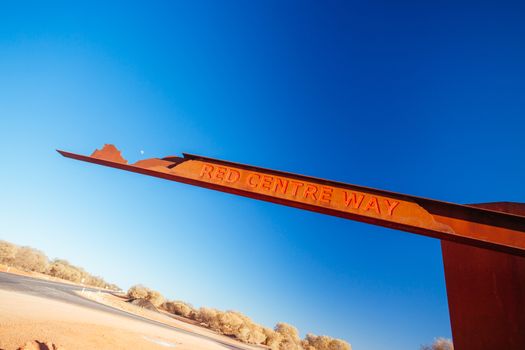 A marker and information spot for Lasseter Hwy directing towards Uluru and Kings Canyon in the Northern Territory, Australia