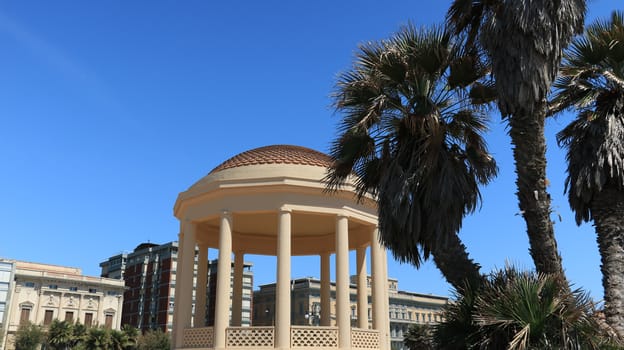 Circular gazebo temple of music near the Mascagni terrace. The small building is built near the sea and the aquarium. Livorno, Tuscany, Italy. 