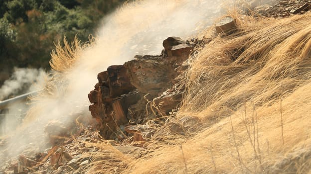 Volcanic fumaroles in the geothermal field. Jets of steam come out of the earth. Monterotondo, Larderello, Tuscany, Italy. 