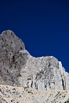 The precious white Carrara marble has been extracted from the Alpi Apuane quarries since Roman times. Today workers are helped by mechanical equipment (excavators, diamond wire machines and transport trucks).