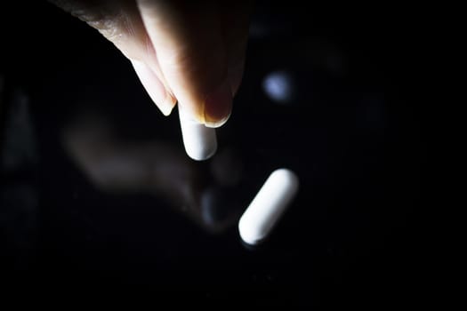 Woman holding generic white medicine pills