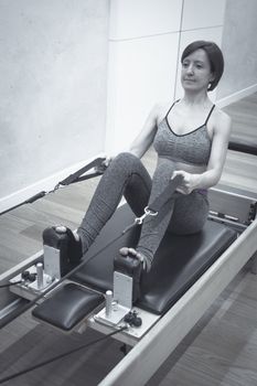 Woman doing pilates machine exercises