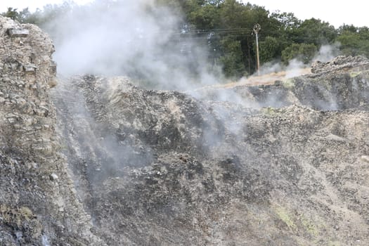 Volcanic fumaroles in the geothermal field. Jets of steam come out of the earth. Monterotondo, Larderello, Tuscany, Italy. 