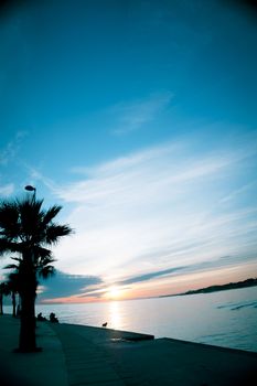 Beautiful sunset on the beach with palm trees. No people