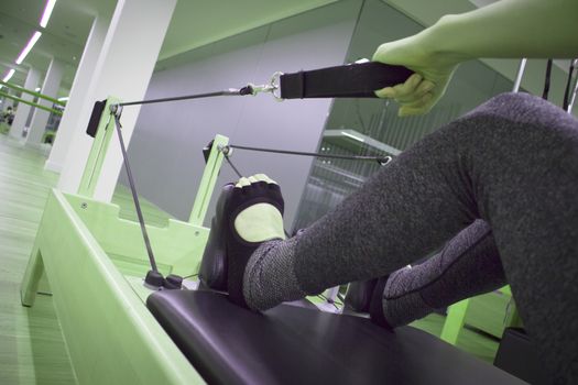 Woman doing pilates machine exercises