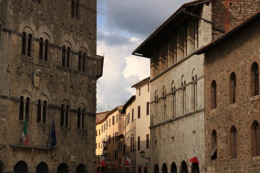 Massa Marittima, Maremma, Tuscany, Italy. About september 2019. Ancient medieval buildings in Massa Marittima in Tuscany. Stone facades with mullioned windows.