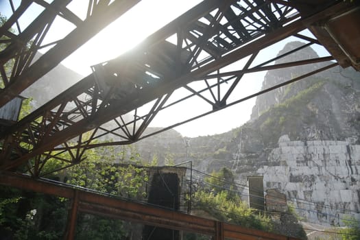 White Carrara marble quarries in the Apuan Alps in Tuscany. Steel structure of an old overhead crane.