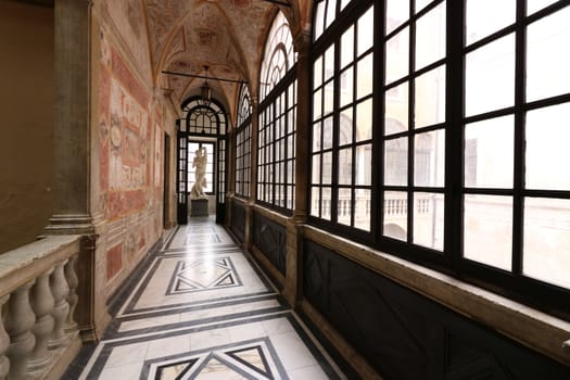 Carrara, Italy. About 6/2016. Inside of the Carrara Academy of Fine Arts. Marble floors, sculptures, reliefs and stained glass windows.