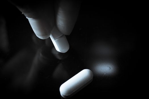 Woman holding generic white medicine pills