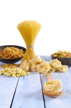 Pasta on a wooden table of kitchen.