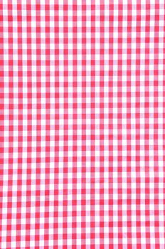 A red checkered fabric closeup tablecloth texture.