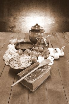 Cookbook over the kitchen table with ingredients.