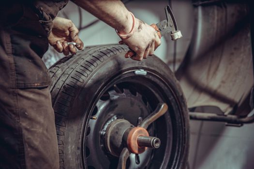 wheel balancing on special machine by adding the weights in the tire service.