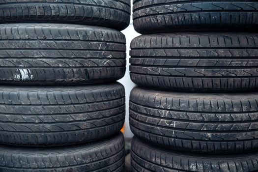 Tire sets in a car repair shop ready for a seasonal change on cars