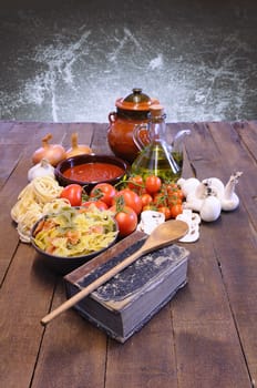 Cookbook over the kitchen table with ingredients.