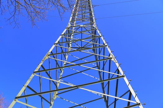 Close up view on a big power pylon transporting electricity in a countryside area in Europe