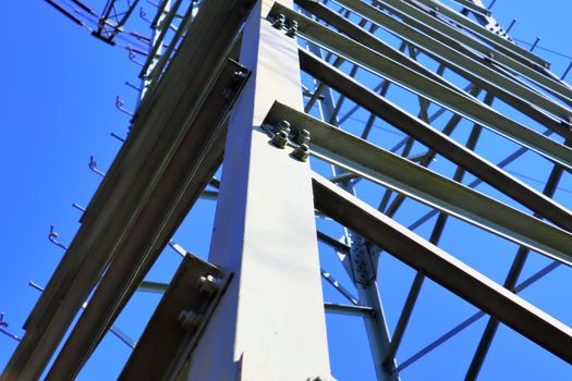 Close up view on a big power pylon transporting electricity in a countryside area in Europe