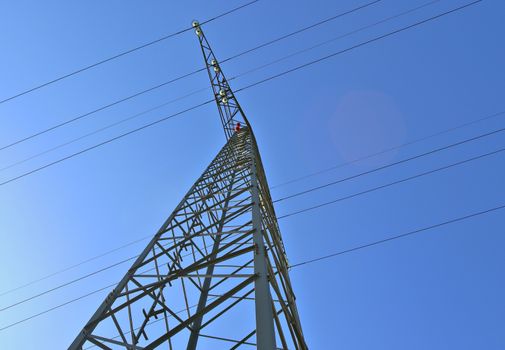 Close up view on a big power pylon transporting electricity in a countryside area in Europe