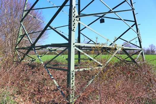 Close up view on a big power pylon transporting electricity in a countryside area in Europe