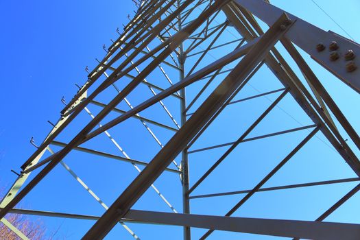 Close up view on a big power pylon transporting electricity in a countryside area in Europe