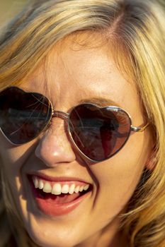 A gorgeous blonde model enjoys a summers day outdoors in a park