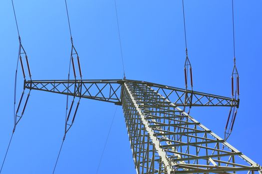 Close up view on a big power pylon transporting electricity in a countryside area in Europe