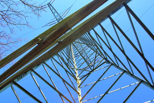 Close up view on a big power pylon transporting electricity in a countryside area in Europe