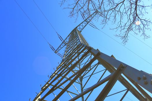 Close up view on a big power pylon transporting electricity in a countryside area in Europe